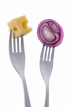 emmentaler cheese - sliced red onion and emmental cheese on forks against a white background Stock Photo - Budget Royalty-Free & Subscription, Code: 400-06464668
