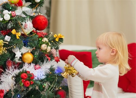 people decorate christmas tree - Baby decorating Christmas tree Stock Photo - Budget Royalty-Free & Subscription, Code: 400-06464743