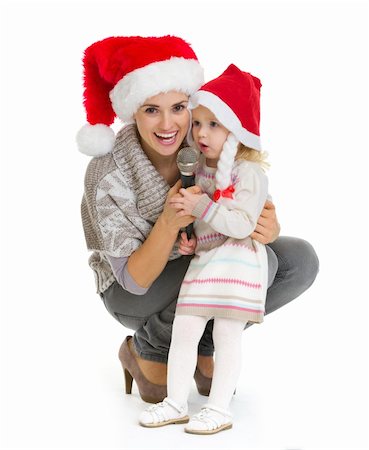 Christmas portrait of happy mother and baby girl singing into microphone Stock Photo - Budget Royalty-Free & Subscription, Code: 400-06464827