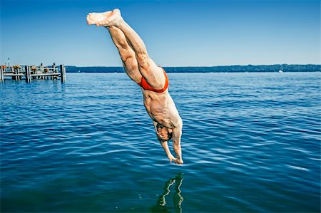 foot jump - An image of a man jumping into the water Stock Photo - Budget Royalty-Free & Subscription, Code: 400-06460642