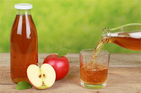 Fresh apple juice is pouring from a bottle into a glass Stock Photo - Budget Royalty-Free & Subscription, Code: 400-06460697