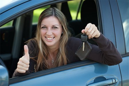 drivers licence - A happy driver leaning out of the window and showing the car key Stock Photo - Budget Royalty-Free & Subscription, Code: 400-06460763