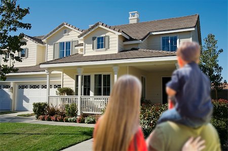 family with sold sign - Young Family Looking at a Beautiful New Home. Stock Photo - Budget Royalty-Free & Subscription, Code: 400-06461055