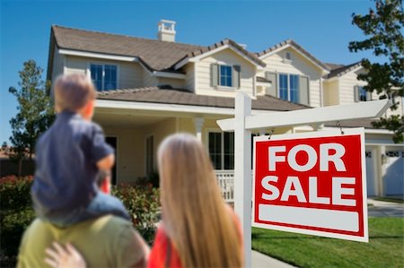 family with sold sign - Young Family Looking at a Beautiful New Home with a For Sale Real Estate Sign in Front. Stock Photo - Budget Royalty-Free & Subscription, Code: 400-06461056