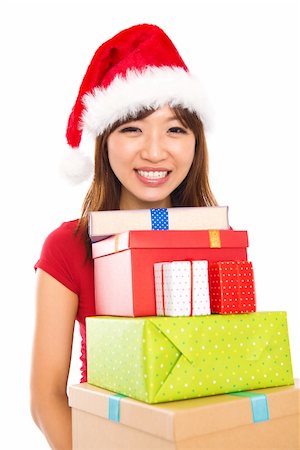 simsearch:400-06477682,k - Beautiful Christmas shopping woman holding many Christmas gifts in her arms wearing santa hat, isolated on white background. Stock Photo - Budget Royalty-Free & Subscription, Code: 400-06461685