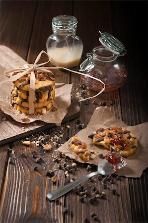 simsearch:400-06462101,k - Side view of peanut cookies, chocolate drops and jars with jam and condensed milk made in the dark tonality Stock Photo - Budget Royalty-Free & Subscription, Code: 400-06462102