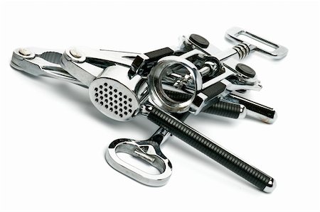 presse d'ail - Heap of Kitchen Tools with Corkscrew, Garlic Press, Nutcracker and Openerisolated on white background Photographie de stock - Aubaine LD & Abonnement, Code: 400-06462331