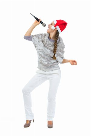 santa christmas hat women - Happy woman in Santa hat singing in microphone Stock Photo - Budget Royalty-Free & Subscription, Code: 400-06462459