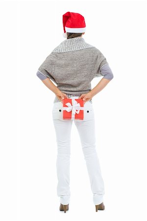 Woman hiding Christmas gift box behind back. Rear view Stock Photo - Budget Royalty-Free & Subscription, Code: 400-06462527