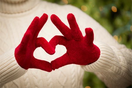 simsearch:400-06462603,k - Woman in Sweater with Seasonal Red Mittens Holding Out a Heart Sign with Her Hands. Stock Photo - Budget Royalty-Free & Subscription, Code: 400-06462603