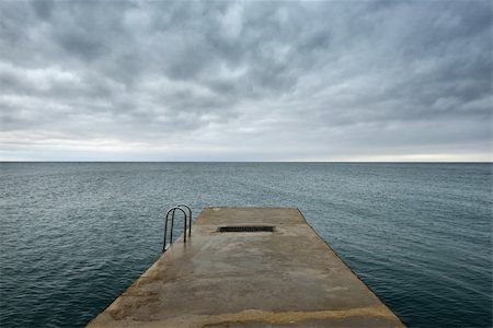 Pier on the sea before the storm dramatic clouds Stock Photo - Budget Royalty-Free & Subscription, Code: 400-06463529