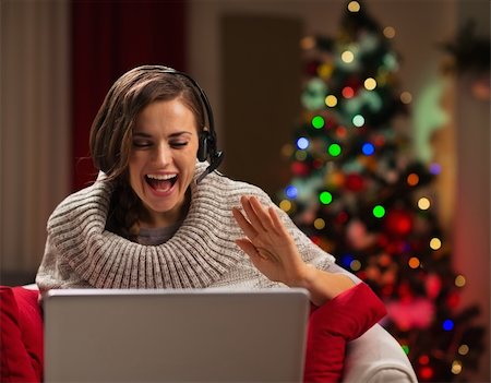 Happy young woman having Christmas video chat with family Photographie de stock - Aubaine LD & Abonnement, Code: 400-06463589