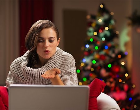 Happy young woman having Christmas video chat with lover Photographie de stock - Aubaine LD & Abonnement, Code: 400-06463590