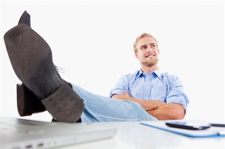 relaxed young man at office with his feet on the desk Stock Photo - Budget Royalty-Free & Subscription, Code: 400-06463922