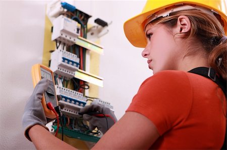 Woman measuring electrical current Stock Photo - Budget Royalty-Free & Subscription, Code: 400-06476987