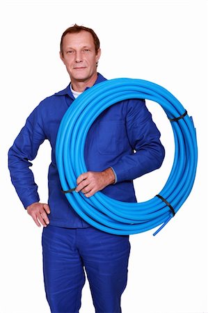 plumber (male) - Plumber with a reel of blue pipe Stock Photo - Budget Royalty-Free & Subscription, Code: 400-06476994