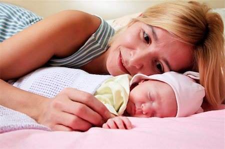 Mother with her sleeping newborn baby in home Stock Photo - Budget Royalty-Free & Subscription, Code: 400-06477006