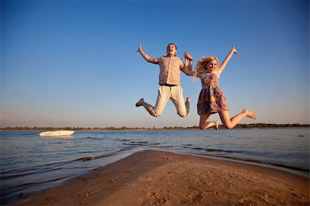 simsearch:400-06751687,k - happy couple jumping on the beach Stock Photo - Budget Royalty-Free & Subscription, Code: 400-06477550