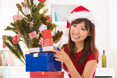 simsearch:400-06477682,k - Beautiful Asian female preparing for Christmas day, indoor / inside home. Stock Photo - Budget Royalty-Free & Subscription, Code: 400-06477671