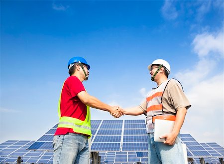 engineers outside plant exterior - two engineers handshaking  before large solar power station Stock Photo - Budget Royalty-Free & Subscription, Code: 400-06478475