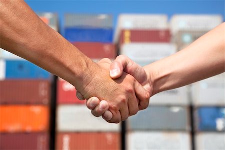 pile hands bussiness - two business man handshaking before stack of containers Stock Photo - Budget Royalty-Free & Subscription, Code: 400-06478473