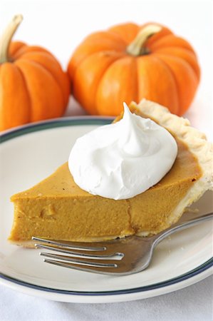 simsearch:400-04852542,k - Slice of delicious holiday pumpkin pie garnished with a dollop of whipped cream. Stockbilder - Microstock & Abonnement, Bildnummer: 400-06478855