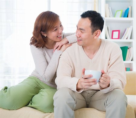 Asian couple having conversation at home Stock Photo - Budget Royalty-Free & Subscription, Code: 400-06479273