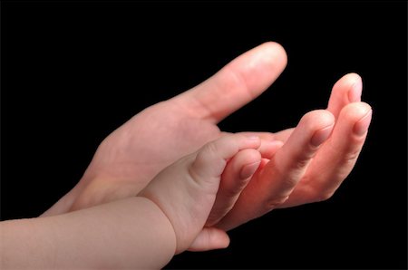 father holding a baby in his hands - A young infant hand in hand with father Stock Photo - Budget Royalty-Free & Subscription, Code: 400-06479459