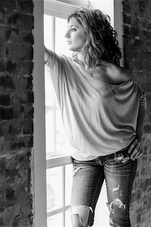 Attractive young woman standing by the window Stock Photo - Budget Royalty-Free & Subscription, Code: 400-06479631