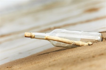 concept with bottle on the beach , selective focus on the cork Stock Photo - Budget Royalty-Free & Subscription, Code: 400-06471362