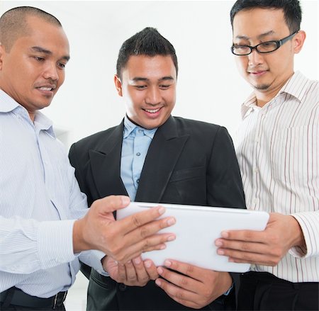 Southeast Asian businessmen having a discussion in office background Stock Photo - Budget Royalty-Free & Subscription, Code: 400-06484571