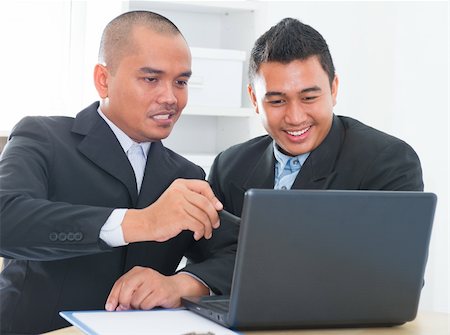 Southeast Asian businessteam discuss in office Stock Photo - Budget Royalty-Free & Subscription, Code: 400-06484573