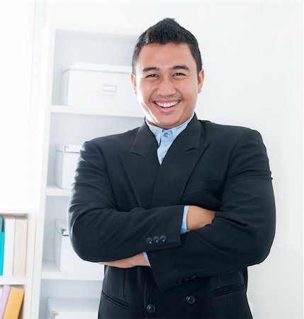 Young Southeast Asian executive standing in office Stock Photo - Budget Royalty-Free & Subscription, Code: 400-06484581