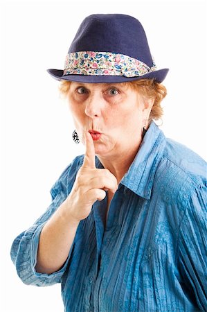 Middle aged woman puts her finger to her lips in a quiet or secret gesture.  Isolated on white. Foto de stock - Super Valor sin royalties y Suscripción, Código: 400-06484908