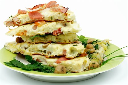 Stack of Various Omelets with  Champignons, Tomatoes, Greens and Bacon closeup Lateral View Stock Photo - Budget Royalty-Free & Subscription, Code: 400-06484958