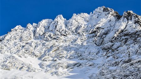 simsearch:400-05038432,k - Winter rocky mountain peak in High Tatras, Slovakia, with blue sky background Stock Photo - Budget Royalty-Free & Subscription, Code: 400-06485080