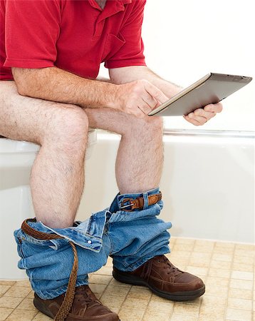 Man sitting on the toilet using his tablet PC. Stock Photo - Budget Royalty-Free & Subscription, Code: 400-06485559