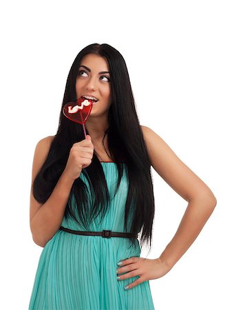 Girl holding heart candy. Studio shot over white background Stock Photo - Budget Royalty-Free & Subscription, Code: 400-06485646