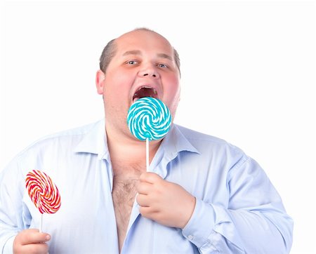 simsearch:400-07305387,k - Fat Man in a Blue Shirt, Eating a Lollipop, isolated Photographie de stock - Aubaine LD & Abonnement, Code: 400-06480140