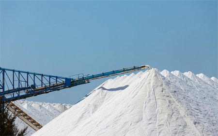 Extraction of salt. Salt mountains on blue sky. Stock Photo - Budget Royalty-Free & Subscription, Code: 400-06480163