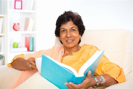 Mature 50s Indian woman reading a book at home Stock Photo - Budget Royalty-Free & Subscription, Code: 400-06481478