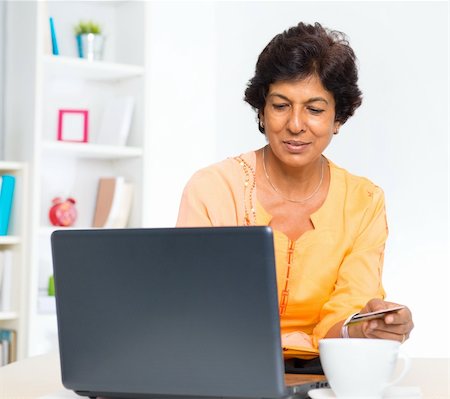 Mature 50s Indian woman holding credit card online shopping at home Stock Photo - Budget Royalty-Free & Subscription, Code: 400-06481500