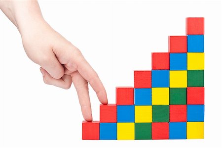 Female hand climbing upstairs which is made from wooden toy blocks Stock Photo - Budget Royalty-Free & Subscription, Code: 400-06481524