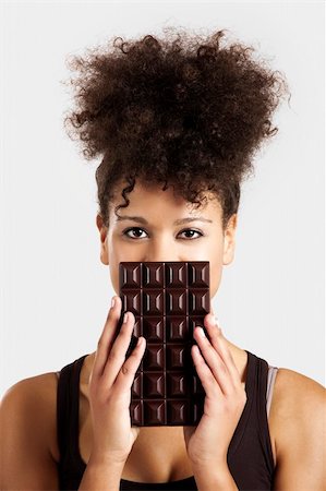 displaying chocolates - Beautiful african woman holding a huge dark chocolate bar Stock Photo - Budget Royalty-Free & Subscription, Code: 400-06481584