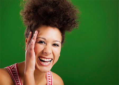 simsearch:400-06065810,k - Beautiful African woman laughing over a green background Foto de stock - Super Valor sin royalties y Suscripción, Código: 400-06481605