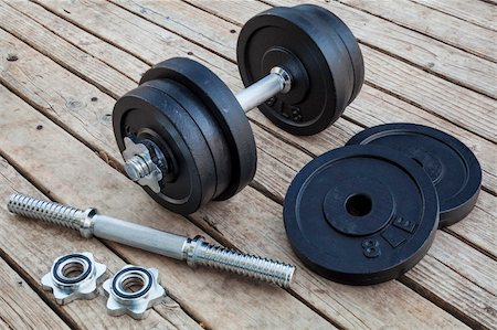 simsearch:400-07620929,k - cast iron dumbbell and weight plates on wooden deck - home gym concept Stock Photo - Budget Royalty-Free & Subscription, Code: 400-06482174
