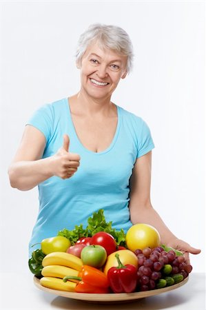 simsearch:400-06482471,k - Elderly woman with fruits and vegetables on a white background Stock Photo - Budget Royalty-Free & Subscription, Code: 400-06482465