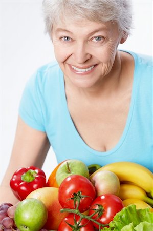 simsearch:400-06482471,k - Elderly woman with fruits and vegetables on a white background Stock Photo - Budget Royalty-Free & Subscription, Code: 400-06482463