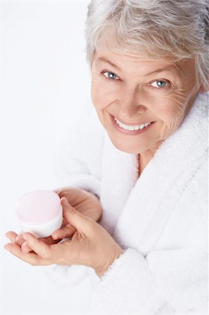 simsearch:400-06482471,k - Elderly woman with cream on a white background Stock Photo - Budget Royalty-Free & Subscription, Code: 400-06482476