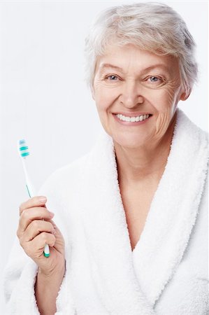 simsearch:400-06482471,k - Elderly woman with a toothbrush on white background Stock Photo - Budget Royalty-Free & Subscription, Code: 400-06482473